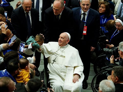 Pope Francis attends a meeting with refugee families at the Paul VI Hall at the Vatican, March 18, 2023.