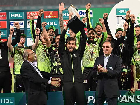 Lahore Qalandars' captain Shaheen Shah Afridi (centre) celebrates with the FSL final trophy during a ceremony at the end of the Pakistan Super League (PSL) Twenty20 cricket final match against Multan Sultans at the Gaddafi Cricket Stadium in Lahore.