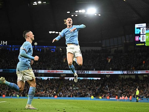 Manchester City's Norwegian striker Erling Haaland (centre) celebrates after scoring the opening goal in the English FA Cup quarter-final match against Burnley at the Etihad Stadium in Manchester, north-west England.