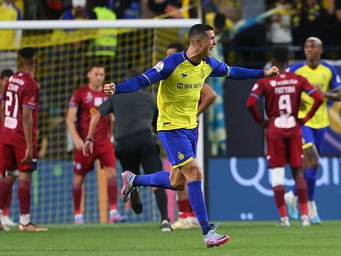 Al Nassr's Portuguese forward Cristiano Ronaldo celebrates after scoring during the Saudi Pro League football match against Abha at Mrsool Park Stadium in Riyadh.