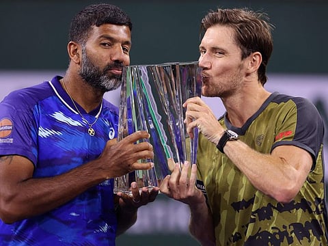 Rohan Bopanna of India (left) and Matthew Ebden of Australia celebrate with the winners trophy after defeating Wesley Koolhof of Netherlands and Neal Skupski of Great Britain in the doubles final during the BNP Paribas Open in Indian Wells, California.