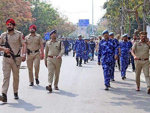 Police and paramilitary personnel conduct a flag march to prevent any untoward incident amid a search to nab Waris Punjab De chief Amritpal Singh, in Jalandhar on Sunday, March 19, 2023.