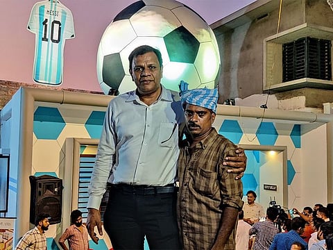 Afi Ahmed (left) and Subair Vazhakkad pose in front of the football house on the housewarming day on Sunday.