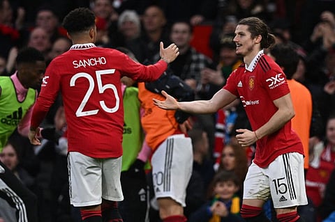 Manchester United midfielder Marcel Sabitzer (right) celebrates with striker Jadon Sancho after scoring their second goal during the English FA Cup quarter-final match against Fulham at Old Trafford in Manchester, north-west Englan.