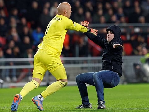 A pitch invader who attacked Sevilla's Marko Dmitrovic has been given a 40-year stadium ban.