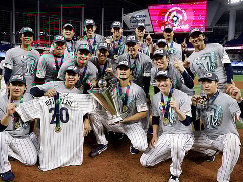 Japan pitcher Yu Darvish (centre) and team Japan celebrate after defeating the USA in the World Baseball Classic final on Tuesday.