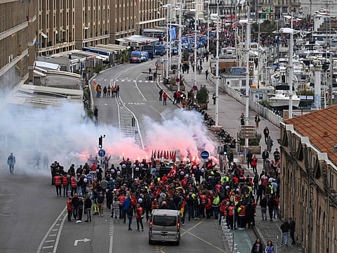 Protesters gather prior to the start of a demonstration on a national action day, a week after the government pushed a pensions reform through parliament without a vote, using the article 49.3 of the constitution, in Marseille, southern France, on March 23, 2023.