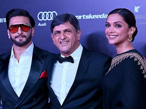 Bollywood actor Ranveer Singh, former Indian badminton player Prakash Padukone and actress Deepika Padukone pose during the 'Indian Sports Honours' in Mumbai on March 23, 2023.