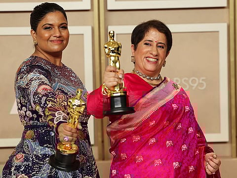 Kartiki Gonsalves and Guneet Monga pose with the Oscar for Best Documentary Short Film for "The Elephant Whisperers" in the Oscars photo room at the 95th Academy Awards in Hollywood, Los Angeles, California, U.S., March 12, 2023.