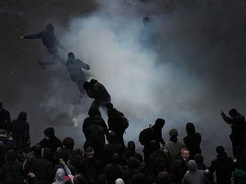 Protesters scuffle at the end of a rally in Paris.