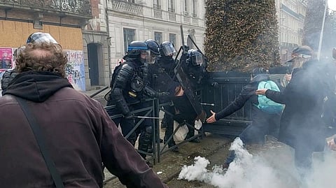 Police officers detain a person during anti-pension reform demonstrations in Rennes, France, March 23, 2023 in this screen grab obtained from a social media video.