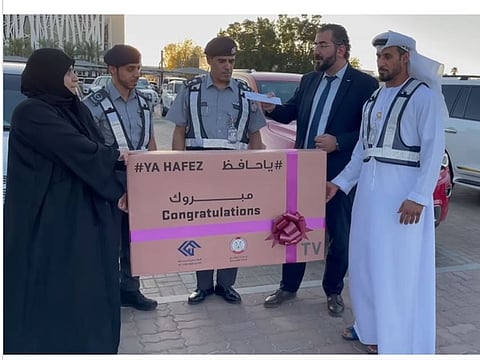 A motorist in Abu Dhabi receiving gift from Abu Dhabi Police officials for safe driving