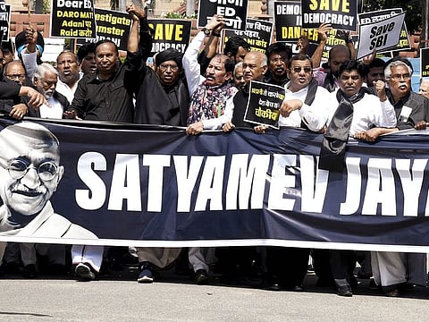 Leader of Opposition Mallikarjun Kharge and Opposition MPs wearing black attire take out a protest march from Parliament complex towards Vijay Chowk over the Adani Group issue, in New Delhi on Monday