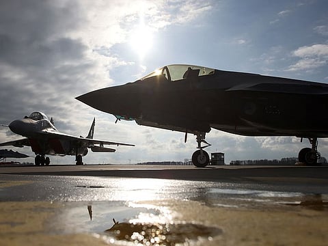 A MiG-29 and F-35 planes are parked on a tarmac during a NATO media event at an airbase in Malbork, Poland, March 21, 2023.
