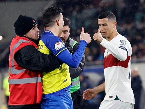 Cristiano Ronaldo (right) winked and gave a pitch invader, dressed in the Al Nassr kit, the thumbs up during Portugal's Euro 2024 qualifier match against Luxembourg at the Stade de Luxembourg, in Luxembourg.