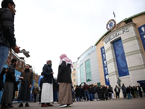 People queue before a pitch side iftar meal at Stamford Bridge stadium, the ground of Chelsea Football Club, during Ramadan in London, Britain. Chelsea will reportedly be forced to sell players this summer to offset their wild spending spree under their new ownership.