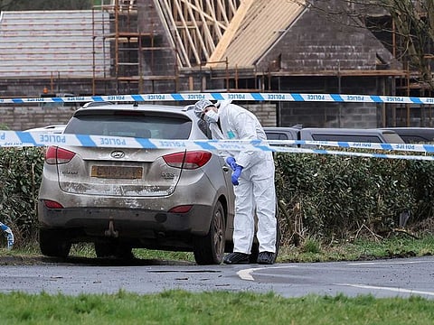 A forensic officer from Police Service of Northern Ireland (PSNI) works at the scene of the Youth Sport Omagh sports complex on Killyclogher Road area, where off-duty PSNI Detective Chief Inspector John Caldwell was shot, in Omagh, Northern Ireland February 23, 2023.