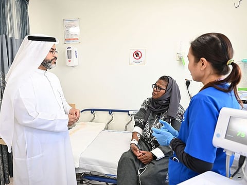 Sameeha (centre), an Emirati, expresses relief following monoclonal antibody therapy in the UAE under the supervision of Dr Khalid Al Naqbi (left), Consultant and Chief of Rheumatology at Tawam, and Adjunct Associate Professor at the UAE University, while a nurse looks on.