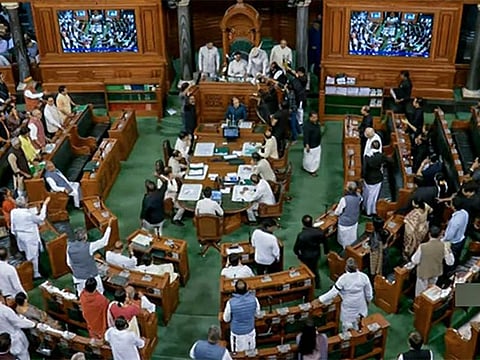Opposition MPs stage a protest in the well of Lok Sabha demanding a JPC inquiry into the Adani Group issue and against the disqualification of Congress' Rahul Gandhi as MP, during the second phase of the Budget Session of Parliament, in New Delhi on Tuesday, March 28, 2023.