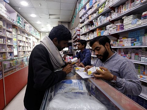 A customer buys medicine from a medical supply store in Karachi on February 9, 2023.