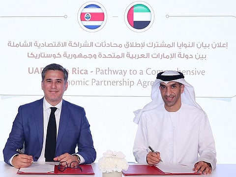 Dr. Thani bin Ahmed Al Zeyoudi and Manuel Tovar Rivera signing a joint statement.