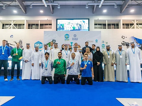 Winners of the fencing competition in the NAS Tournament with the officials at the Nad Al Sheba Sports Complex.