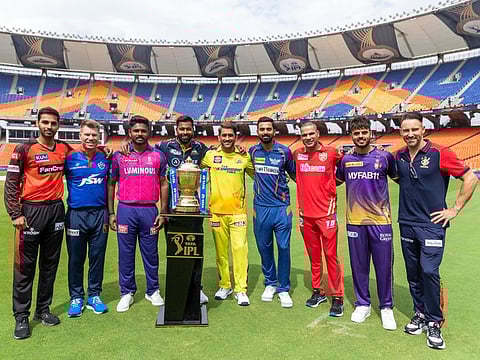 Captains and senior players of the nine Indian Premier League teams with the trophy ahead of the season 16 opener at Narendra Modi Stadium.