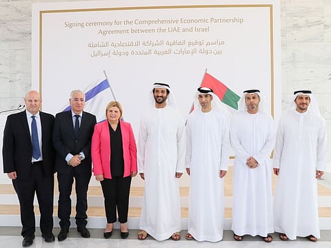 Abdulla Bin Touq Al Marri, UAE Minister of Economy, (fourth from the left) stands alongside; Dr Thani Bin Ahmed Al Zeyoudi, UAE Minister of State for Foreign Trade, (fifth from the left) and Orna Barbivai, former Minister of Economy for Israel (third from the left), and the negotiating teams from each country.