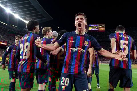 Barcelona's Spanish midfielder Sergi Roberto celebrates with teammates after scoring his team's first goal in the El Clasico against Real Madrid.