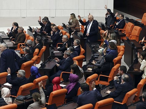 Turkish lawmakers from the Ruling Justice and Development Party lawmakers vote in favour of Finland's bid to join Nato, late Thursday, March 30, 2023, at the parliament in Ankara. All 276 lawmakers present voted unanimously in favour of Finland's bid, days after Hungary's parliament also endorsed Helsinki's accession.