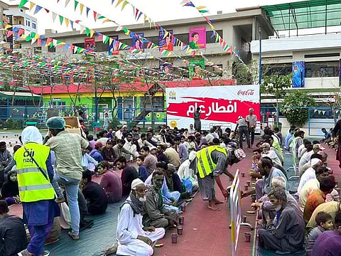Nearly a thousand men, women and children sitting at dastarkhwan arranged by Rizq, waiting to end their fast on March 29, 2023.