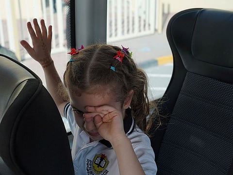 A student on a school bus at a public school in Sharjah during the event
