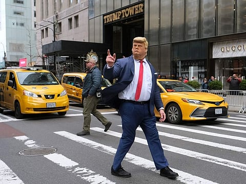 A person with a mask depicting former president Donald Trump poses outside of Trump Tower on March 31, 2023 in New York City.
