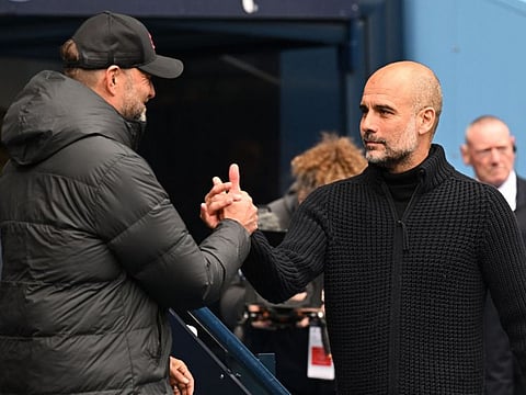 Liverpool manager Jurgen Klopp (left) and Manchester City manager Pep Guardiola shake hands ahead of their English Premier League football match at the Etihad Stadium in Manchester, north west England.
