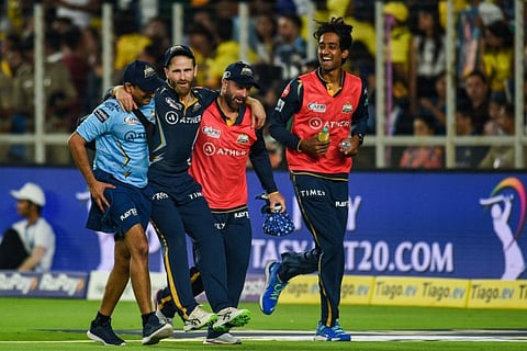 Gujarat Titans' Kane Williamson (centre) is helped by teammates back to pavillion after he was injured during the Indian Premier League match against Chennai Super Kings at the Narendra Modi Stadium in Ahmedabad.