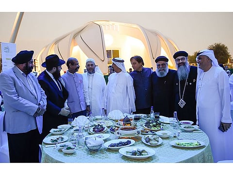 Hamad Al Sheikh Ahmed Al Shaibani (centre), Director-General of the Islamic Affairs and Charitable Activities Department having iftar with people from different faiths at ‘Dubai Iftar’ at Expo City Dubai on Sunday