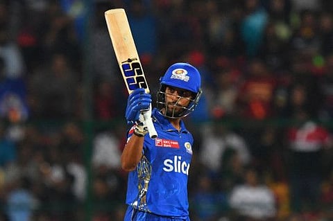Mumbai Indians' Tilak Varma celebrates after scoring a half-century during the Indian Premier League match against Royal Challengers Bangalore at the M Chinnaswamy Stadium in Bengaluru.