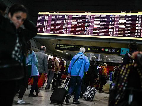 Passengers queue to check-in inside the departures hall during pay-related strike action by EasyJet Plc at Lisbon Airport in Lisbon, Portugal.