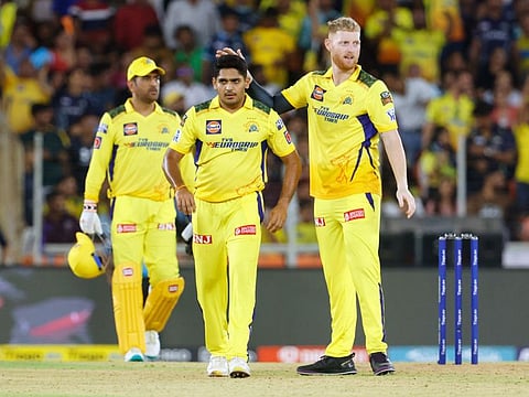 Chennai Super Kings's Tushar Deshpande and Ben Stokes celebrate the dismissal of Gujarat Titans's Shubman Gill during their match in the Indian Premier League at Narendra Modi Stadium, in Ahmedabad.
