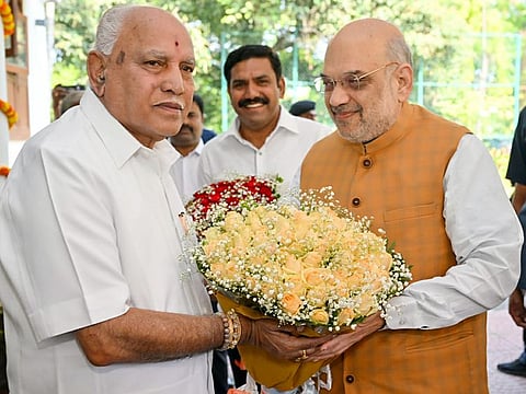 Union Home Minister Amit Shah meets former Karnataka Chief Minister B S Yediyurappa, at the latter's residence, in Bengaluru on Friday. BJP State Vice President and son of B S Yediyurappa, B Y Vijayendra is also seen.