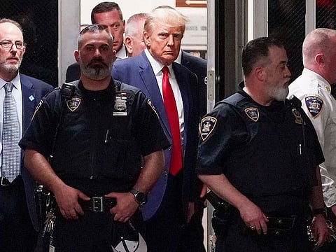 Former President Donald Trump is escorted to a courtroom, Tuesday, April 4, 2023, in New York. Trump appeared in a New York City courtroom on charges related to falsifying business records in a hush-money investigation, the first president ever to be charged with a crime.