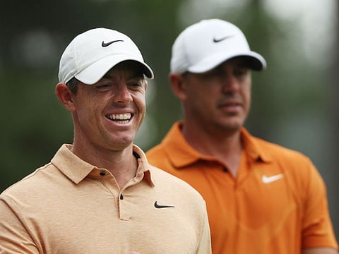 Rory McIlroy of Northern Ireland and Brooks Koepka of the United States look on during a practice round prior to the 2023 Masters Tournament at Augusta National Golf Club on Tuesday.