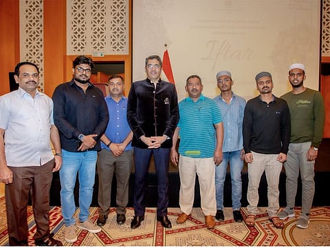 Consul General of India Dr Aman Puri with Indian blue collar workers and their supervisor at an Iftar hosted in Dubai on Tuesday.