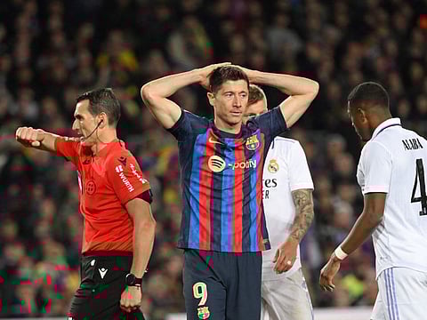Barcelona forward Robert Lewandowski reacts after the Copa del Rey semi-final second leg defeat against Real Madrid CF at the Camp Nou stadium in Barcelona.