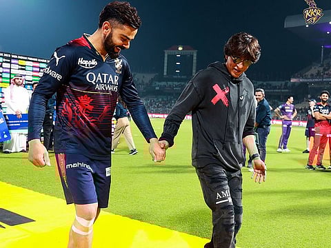 Cricketer Virat Kohli with Bollywood star and owner of the IPL franchise Kolkata Knight Riders, Shah Rukh Khan.