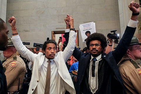 Justin Pearson and Justin Jones raise their hands after being expelled from their seats in Nashville, Tennessee, on April 6, 2023.