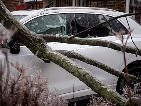 Tree branches fell through a windshield after freezing rain hit parts of Quebec and Ontario in Montreal, Canada, on April 5, 2023. - Hydro Quebec estimated that there are some 600,000 power outages throughout the province of Quebec. (Photo by ANDREJ IVANOV / AFP)