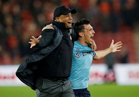 Burnley manager Vincent Kompany (left) celebrates promotion to the Premier League with Jack Cork.