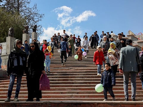 Iranians visit a park on Nature Day in Tehran, on April 2, 2023. Under Iran’s Islamic sharia law, imposed after the 1979 revolution, women are obliged to cover their hair and wear long, loose-fitting clothes to disguise their figures. Violators have faced public rebuke, fines or arrest.