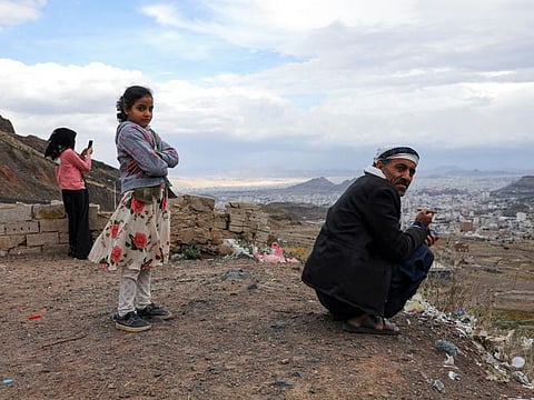 People enjoy the view from a hill overlooking Sana'a as Yemenis live the atmosphere of Ramadan while enjoying a relative calm, the longest stretch in an eight-year civil war, under a UN-brokered truce deal that lapsed in October but had largely held.